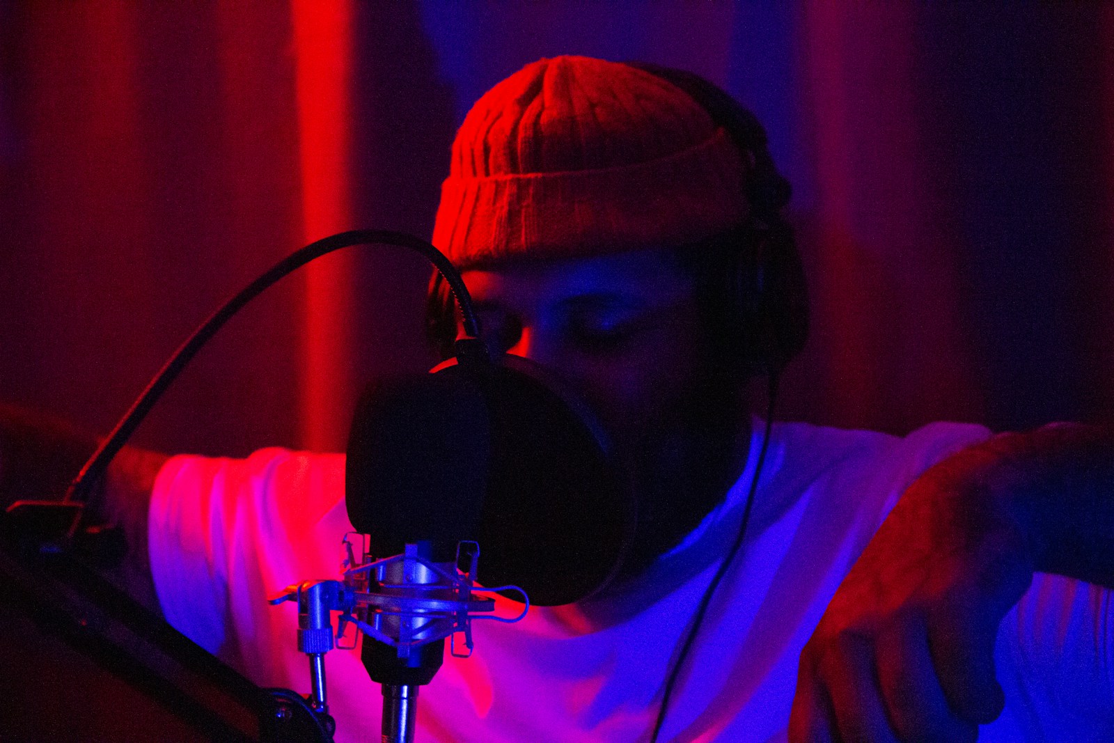 man in white shirt wearing black headphones